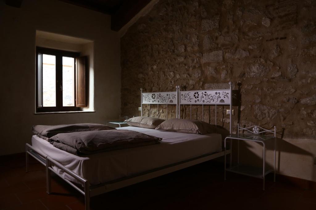 Postel nebo postele na pokoji v ubytování Monastero Di Sant'Erasmo