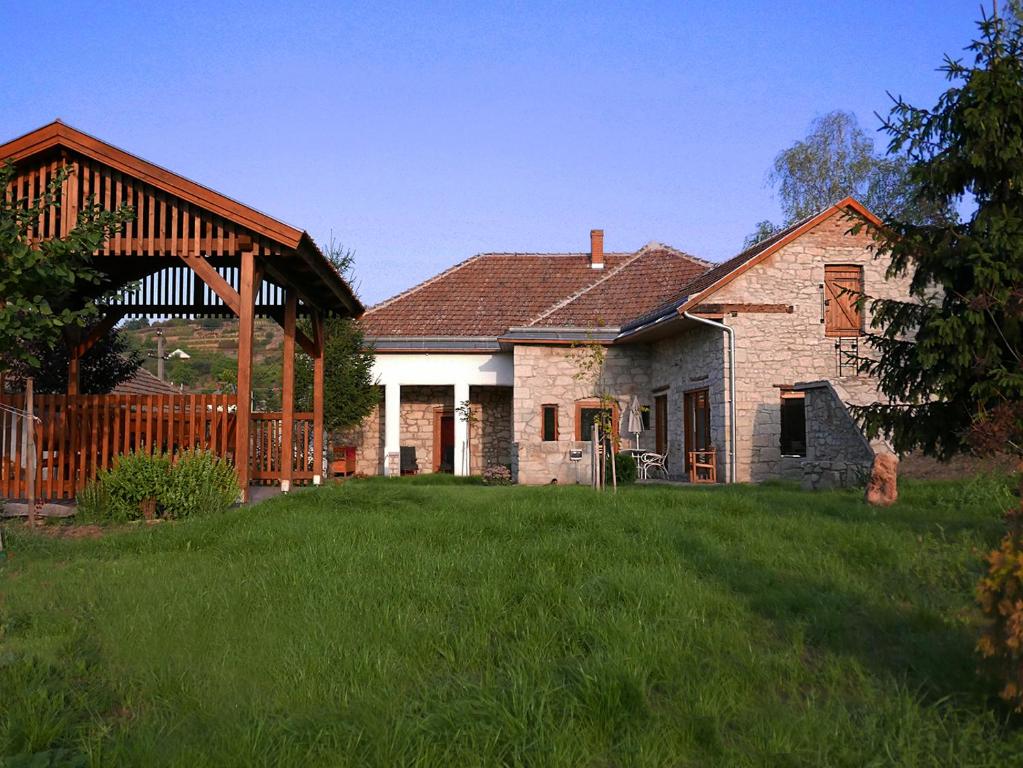 a house with a large lawn in front of it at Úrágya Vendégház in Mád