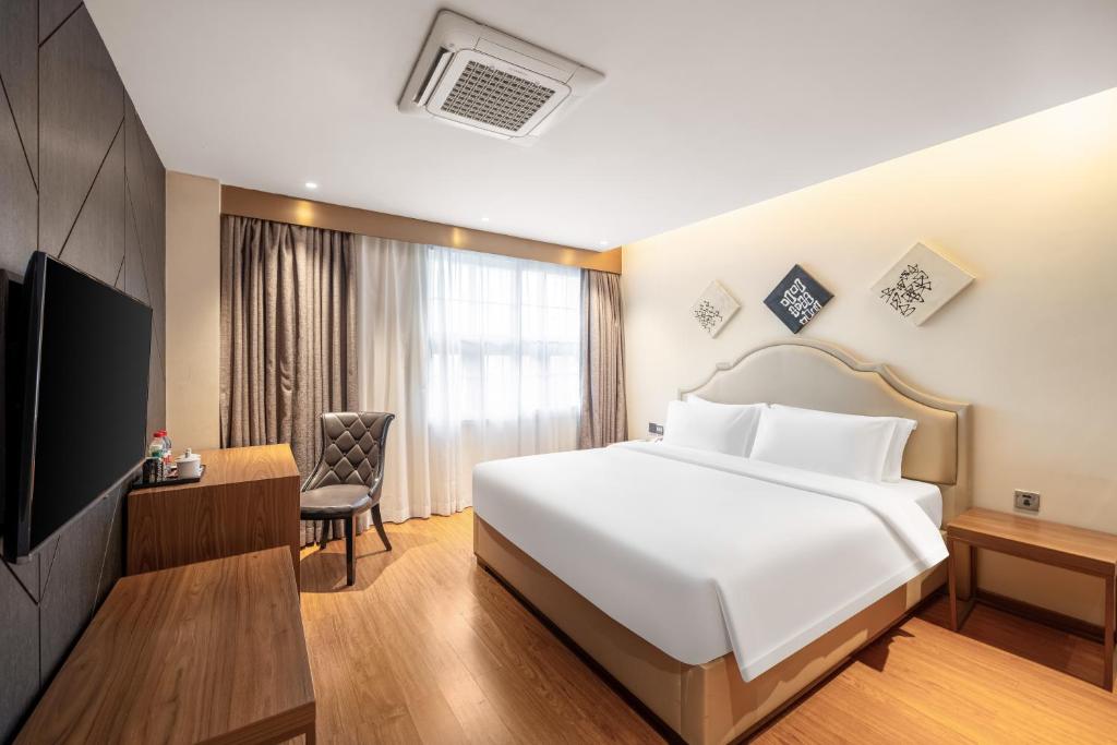 Postel nebo postele na pokoji v ubytování Dayhello Hotel Shenzhen Shekou