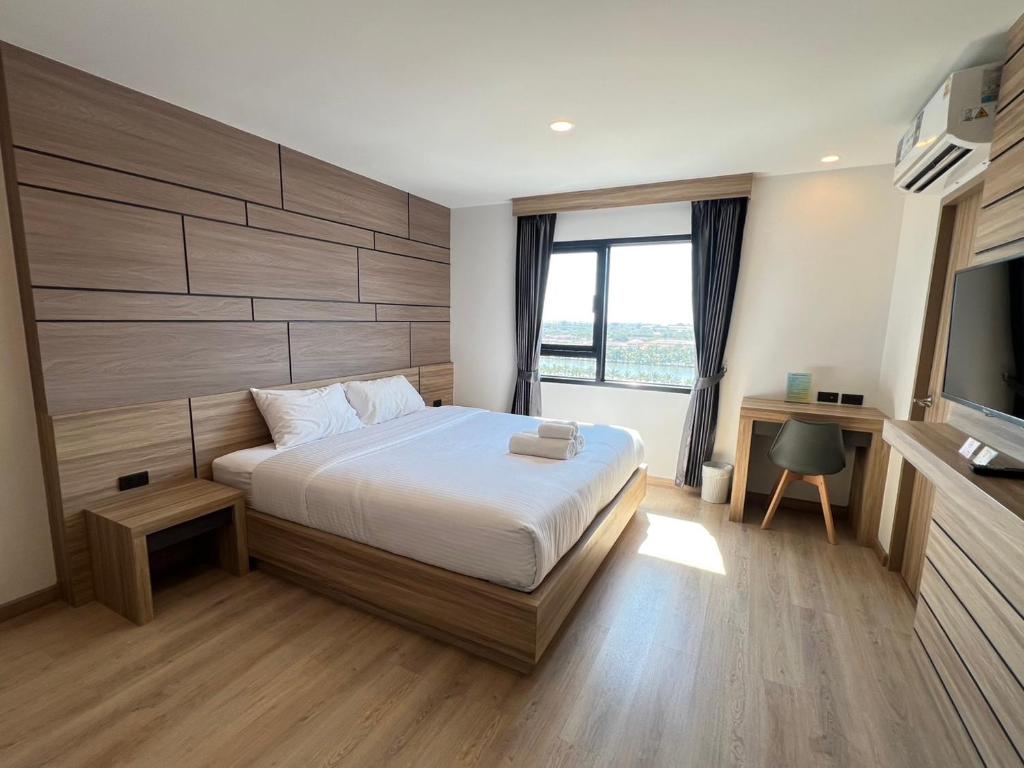 Postel nebo postele na pokoji v ubytování เวลโกรว์ โฮเทล - Wellgrow Hotel