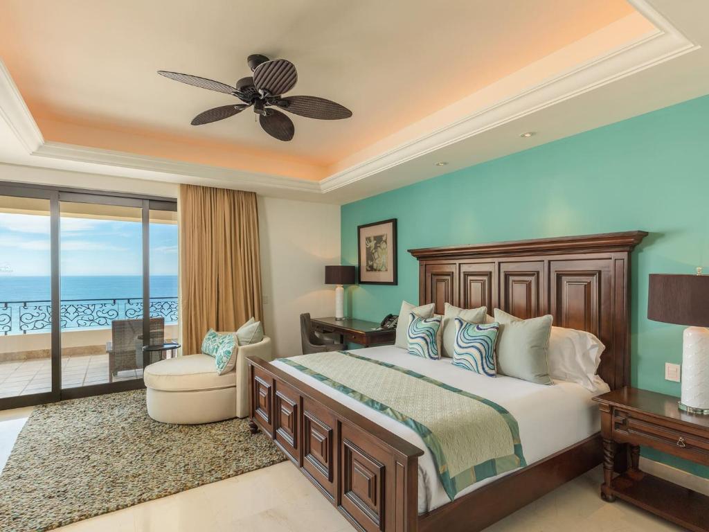 a bedroom with a bed and a view of the ocean at One Bedroom in Cabo San Lucas