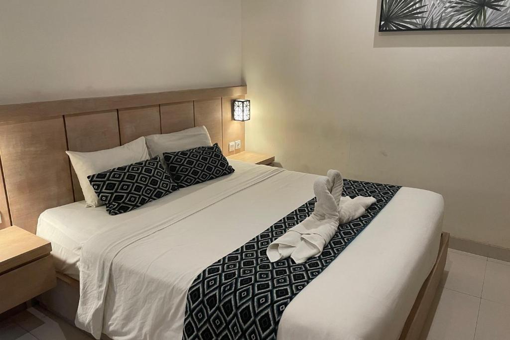 Postel nebo postele na pokoji v ubytování Singgah Hotel Seminyak