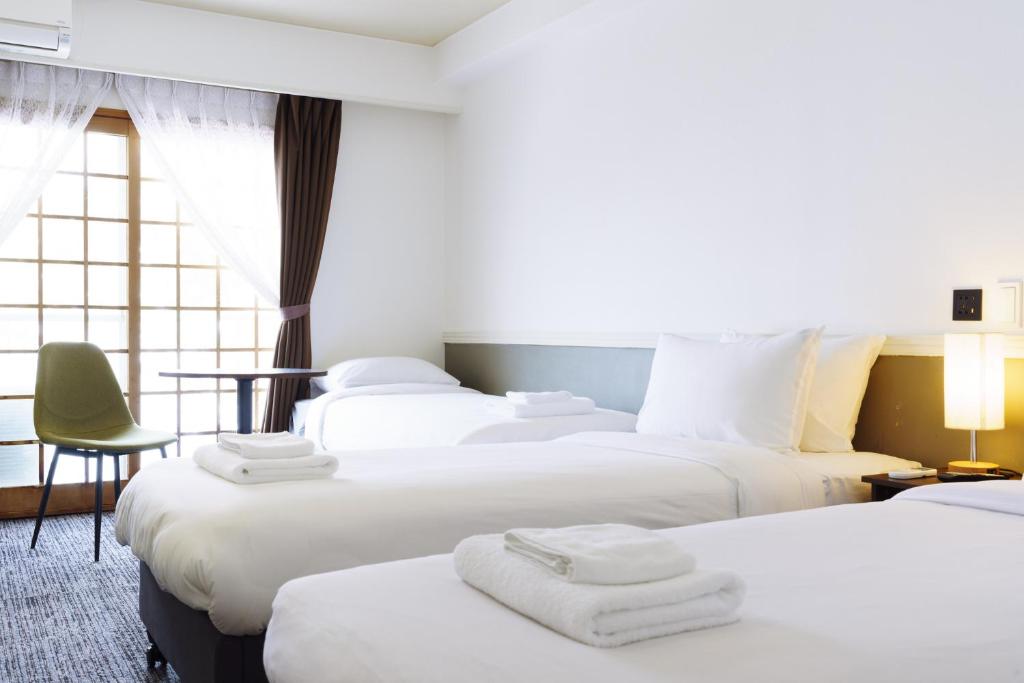 Postel nebo postele na pokoji v ubytování Hakuba Gateway Hotel