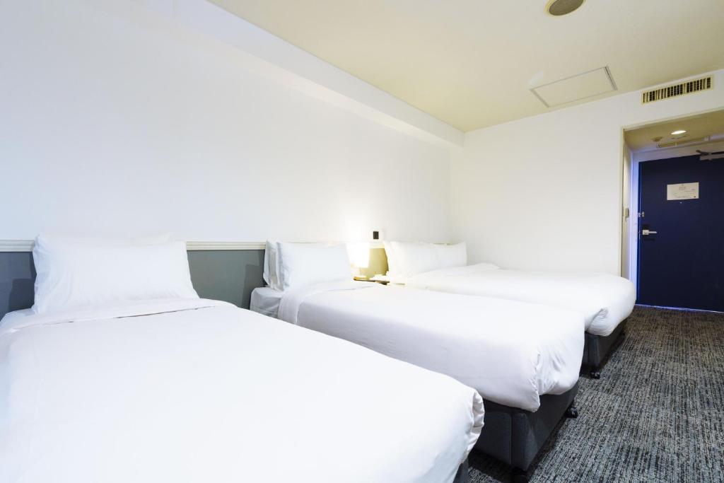 Postel nebo postele na pokoji v ubytování Hakuba Gateway Hotel