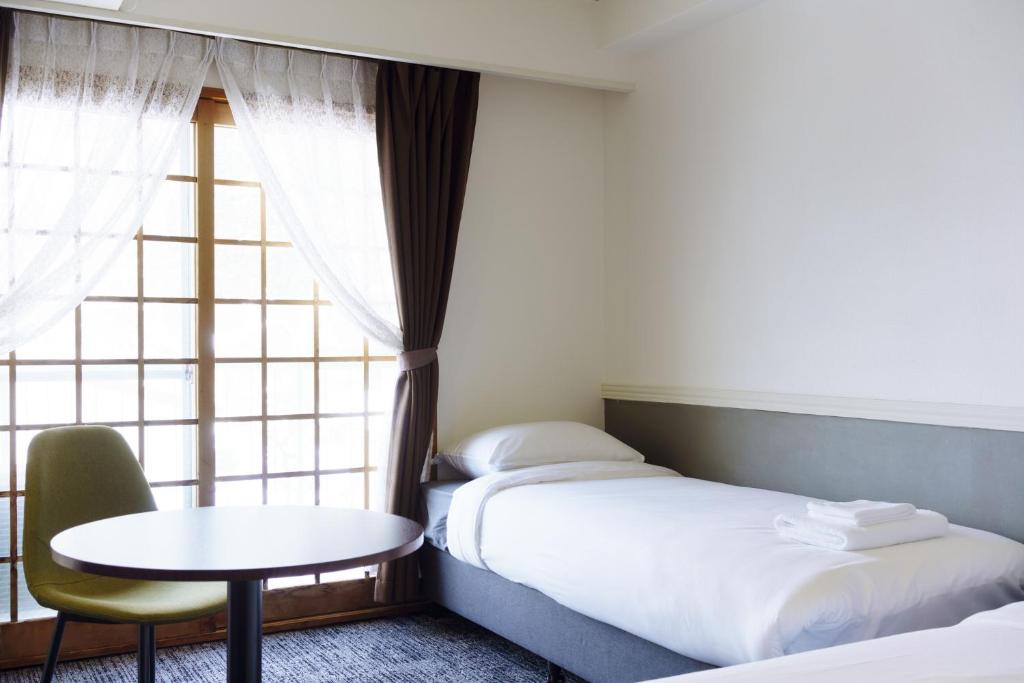 Postel nebo postele na pokoji v ubytování Hakuba Gateway Hotel