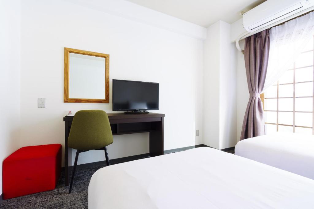 Postel nebo postele na pokoji v ubytování Hakuba Gateway Hotel