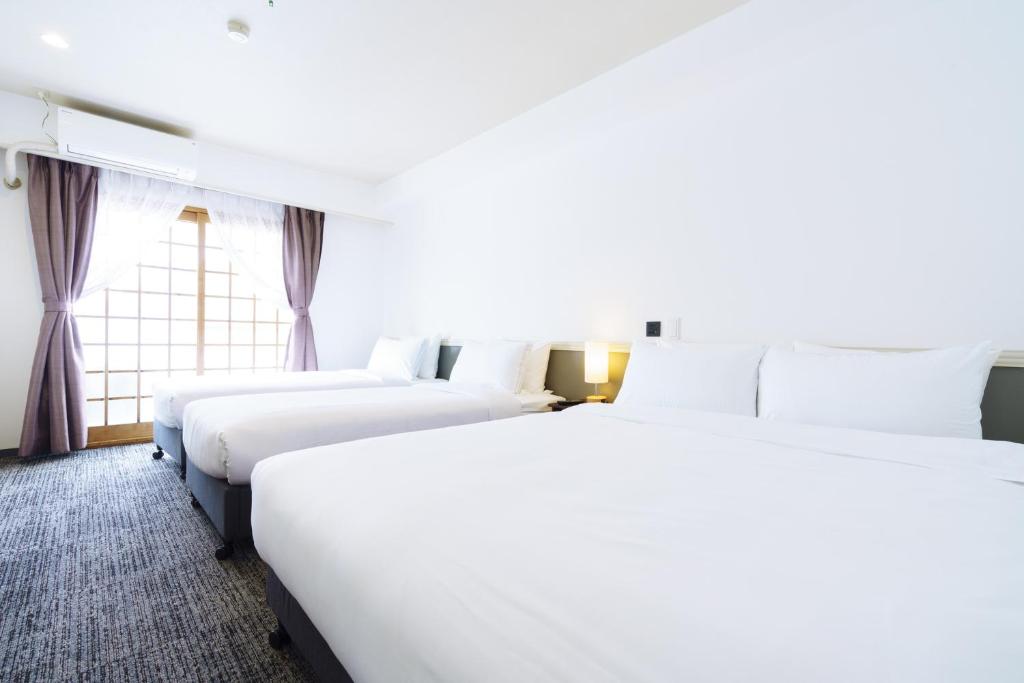 Postel nebo postele na pokoji v ubytování Hakuba Gateway Hotel