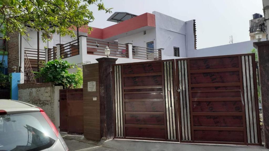 a wooden fence in front of a house at Kanha's Kunj in Prayagraj