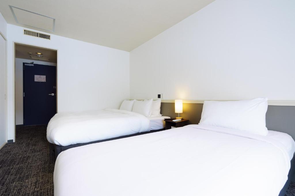 Postel nebo postele na pokoji v ubytování Hakuba Gateway Hotel