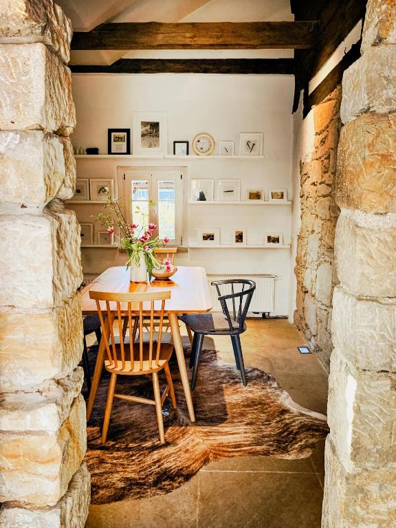 a dining room with a table and chairs at Lovingly Restored Half-Timbered House From 1684 in Großschönau