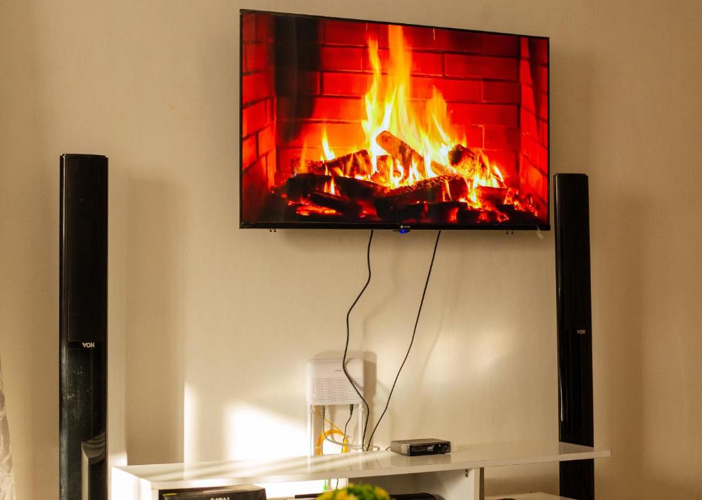 a fireplace in a living room with two speakers at Classic Studio Bamburi in Mombasa