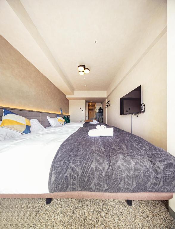 Postel nebo postele na pokoji v ubytování Apartment Hotel 11 Shinsaibashi 2