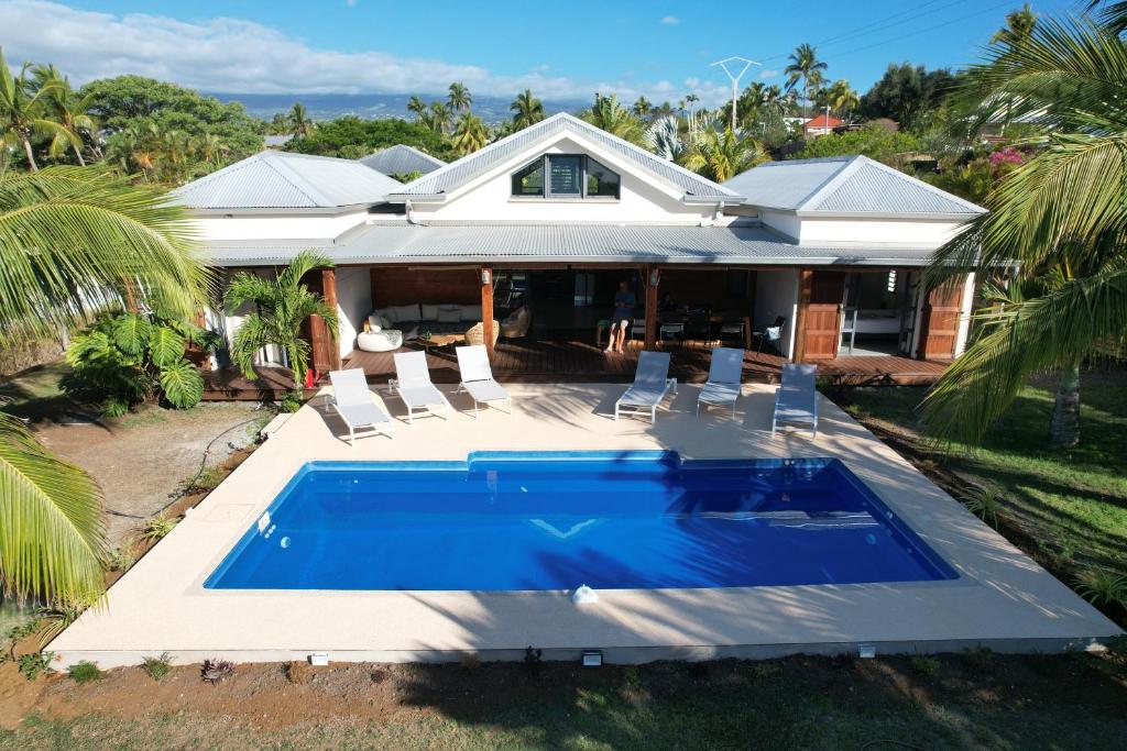 a house with a swimming pool in front of a house at Villa Solemaris 5 étoiles Saint Gilles- Boucan proche plage in Saint-Gilles les Bains