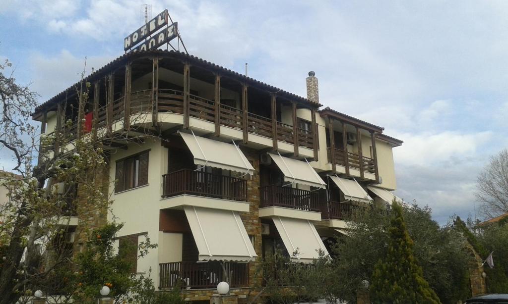 a building with balconies on the side of it at Hotel Ballas in Agria