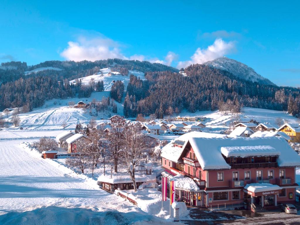 a town covered in snow with a mountain in the background at Hotel Gailtaler Hof in Kötschach