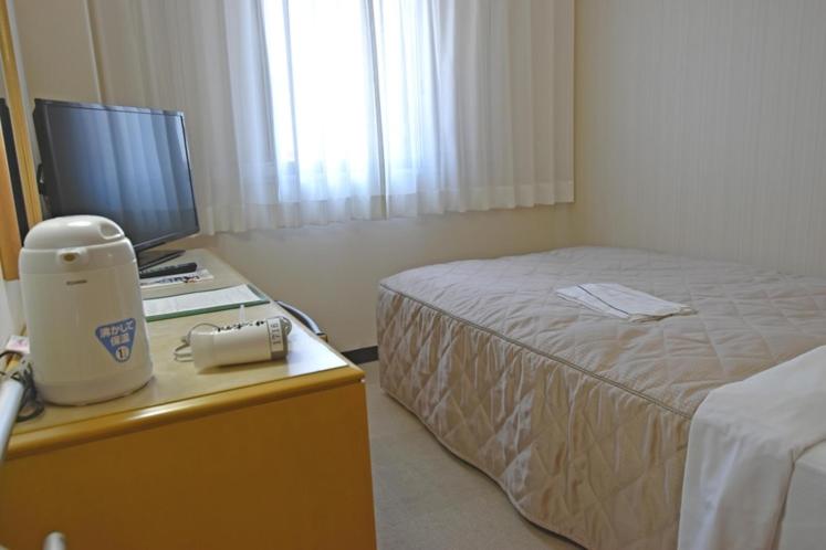 Postel nebo postele na pokoji v ubytování サンホテル八王子