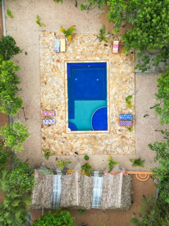 an overhead view of a swimming pool in a backyard at Karibu Maisha Lodge in Kizimkazi