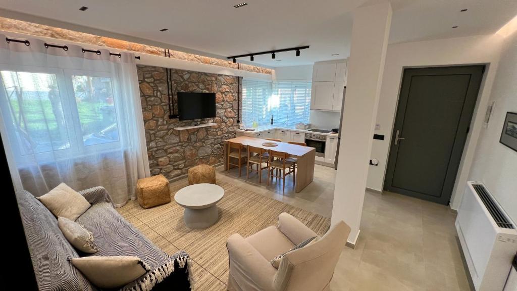 a living room with a couch and a table at Aeolian apartment in Mytilini