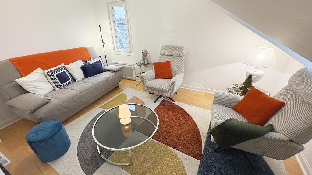 un salon avec un canapé, des chaises et une table dans l'établissement Coup de Coeur Angevin - Hypercentre - Calme - Cozy, à Angers