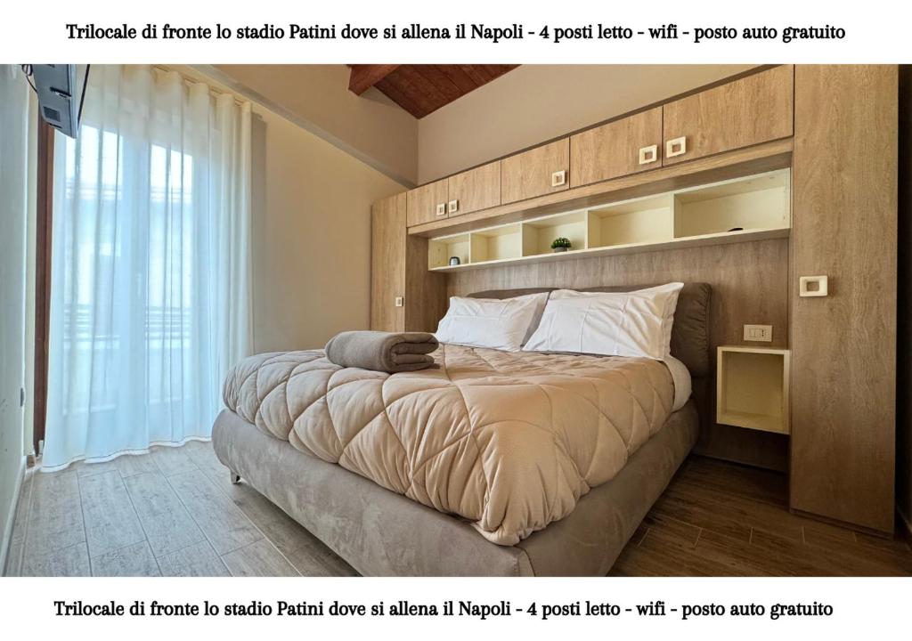 a bedroom with a large bed with a wooden headboard at CASTEL DI SANGRO - casa vacanza con wifi e posto auto vicino lo stadio in Castel di Sangro