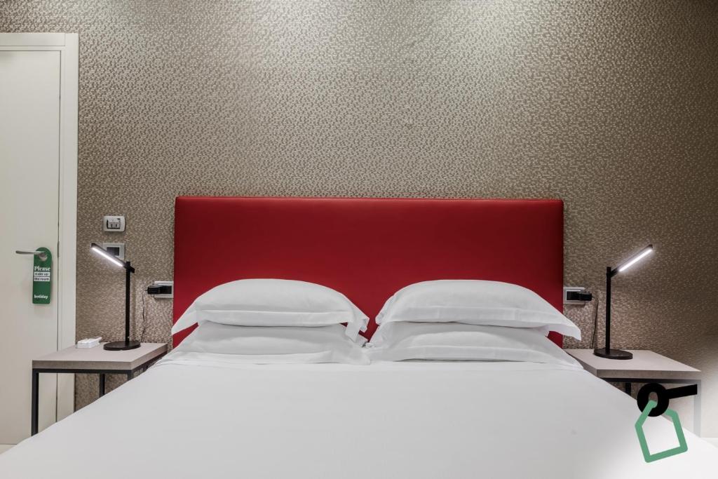 Postel nebo postele na pokoji v ubytování HOTIDAY Apartment Collection - La Spezia