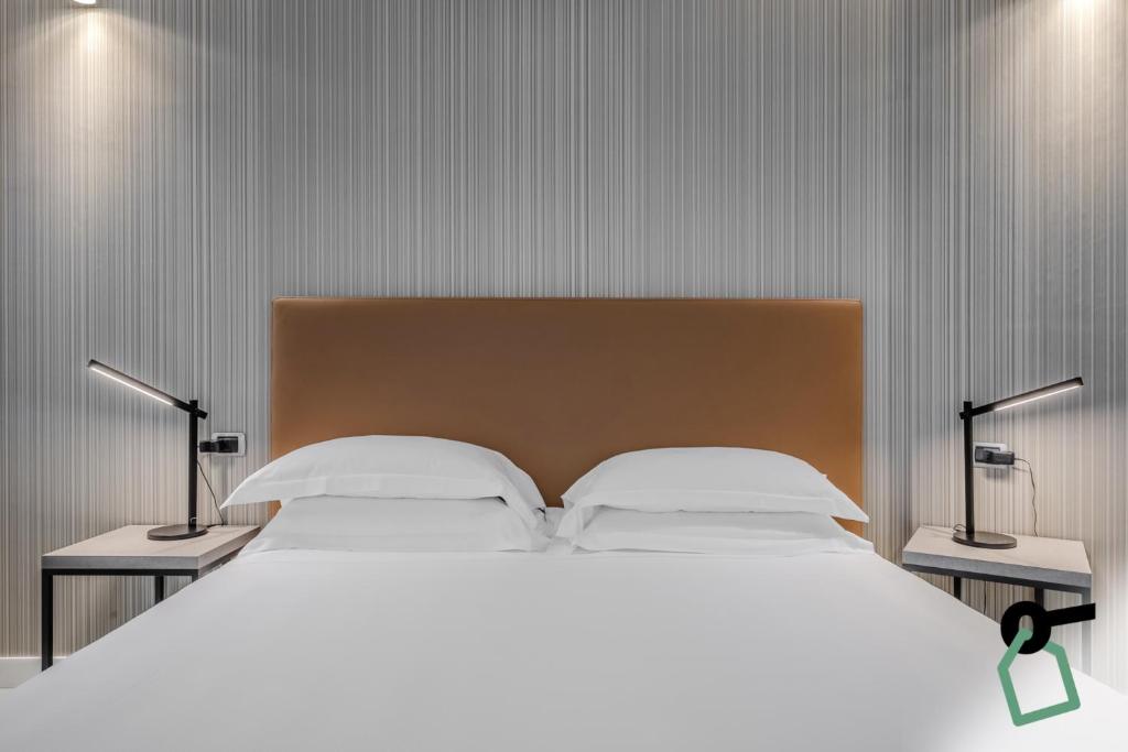 Postel nebo postele na pokoji v ubytování HOTIDAY Apartment Collection - La Spezia