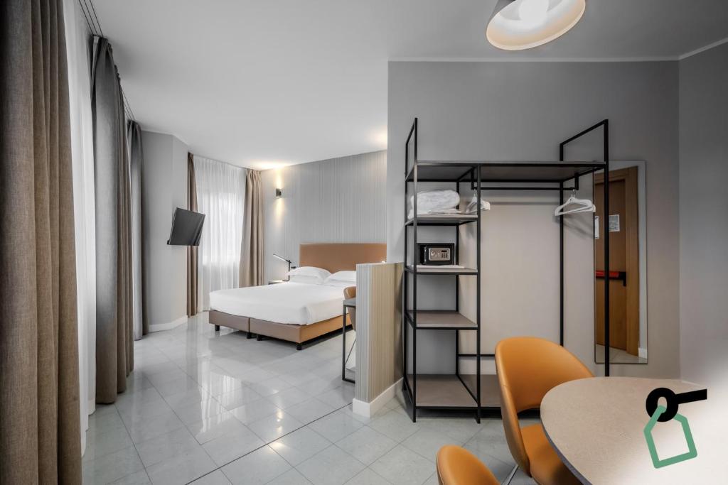 Postel nebo postele na pokoji v ubytování HOTIDAY Apartment Collection - La Spezia