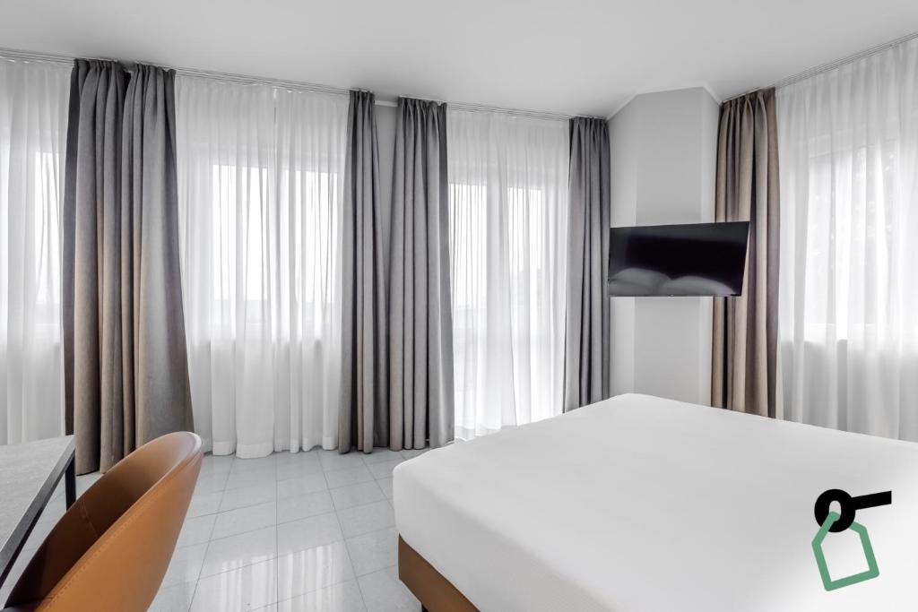 TV a/nebo společenská místnost v ubytování HOTIDAY Apartment Collection - La Spezia
