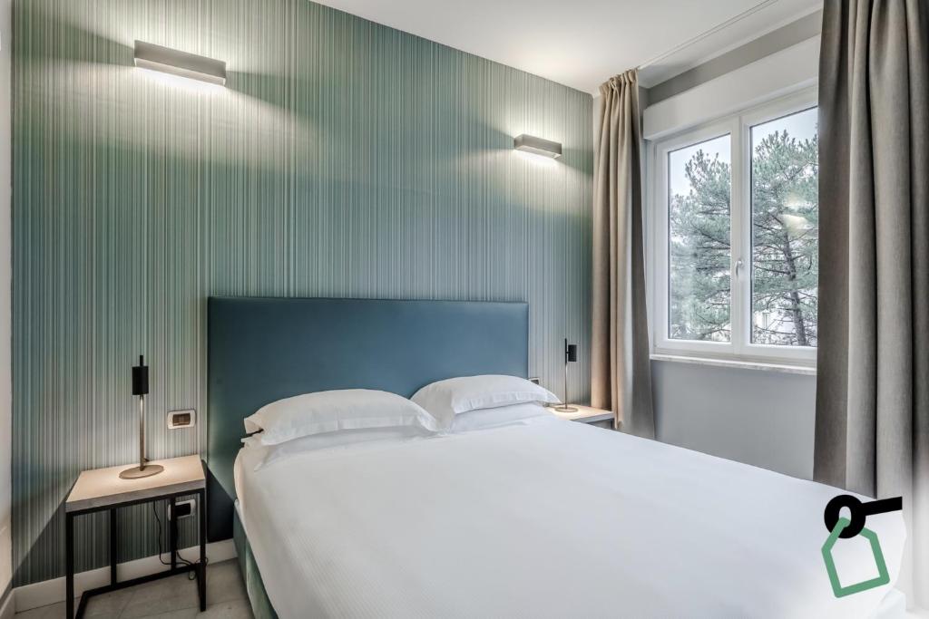Postel nebo postele na pokoji v ubytování HOTIDAY Apartment Collection - La Spezia