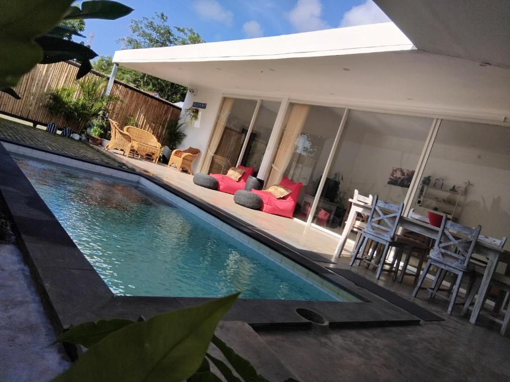 a swimming pool in front of a house at Villa harapan 2 in Kuta Lombok