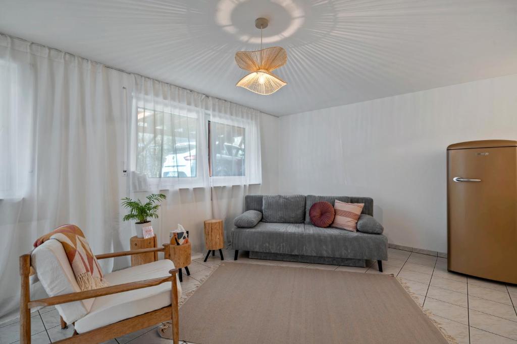 a living room with a couch and a chair at Calm und Cosy direkt am Neckar in Oberndorf am Neckar