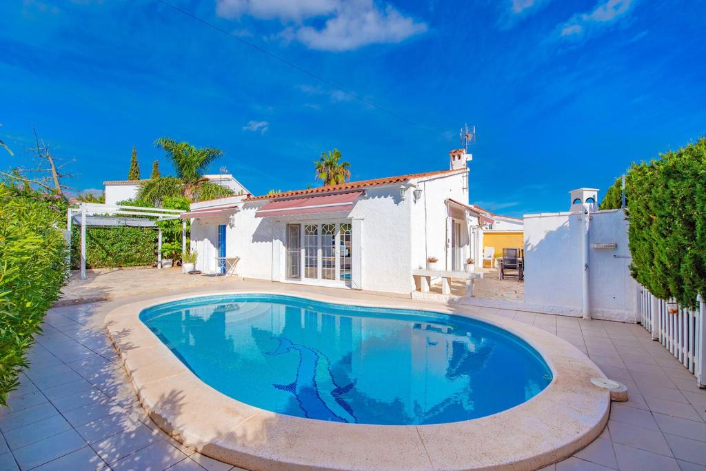 a swimming pool in front of a house at Sunbathing with private swimming pool in Calpe