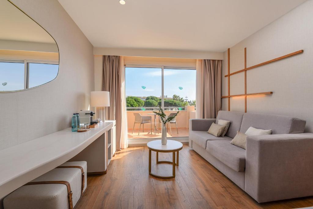 a living room with a couch and a table at Valentin Sancti Petri in Chiclana de la Frontera