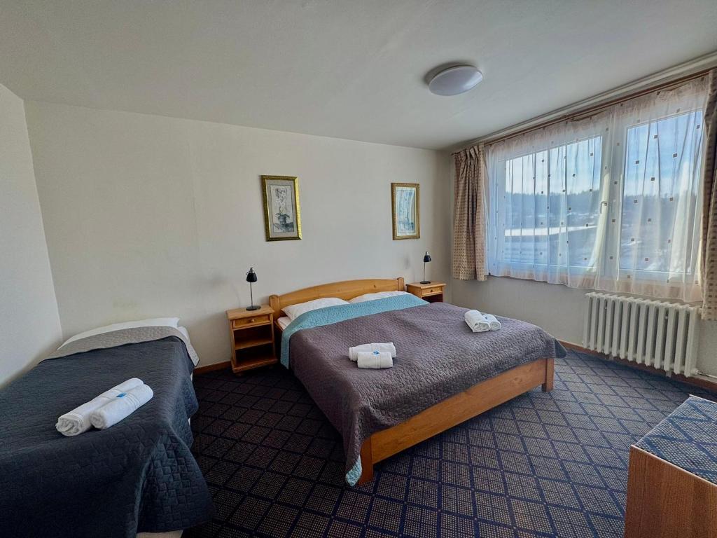 Postel nebo postele na pokoji v ubytování PATRIA HOTEL