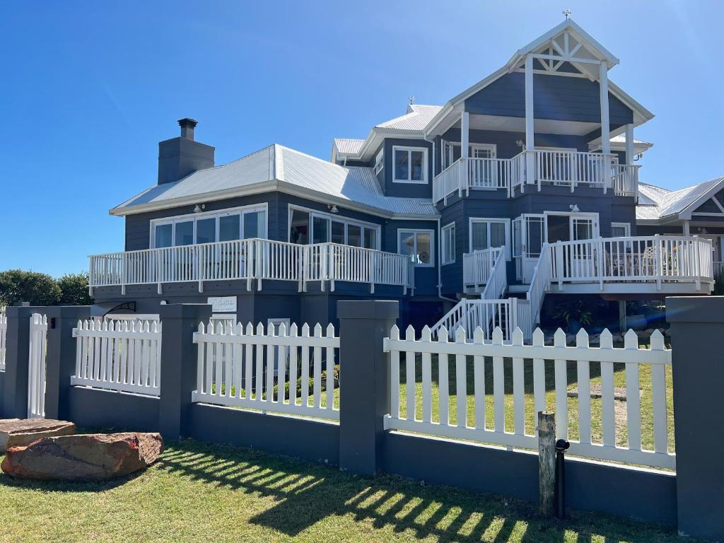 a large house with a white picket fence at SandDollar - Entire house in Cape St Francis