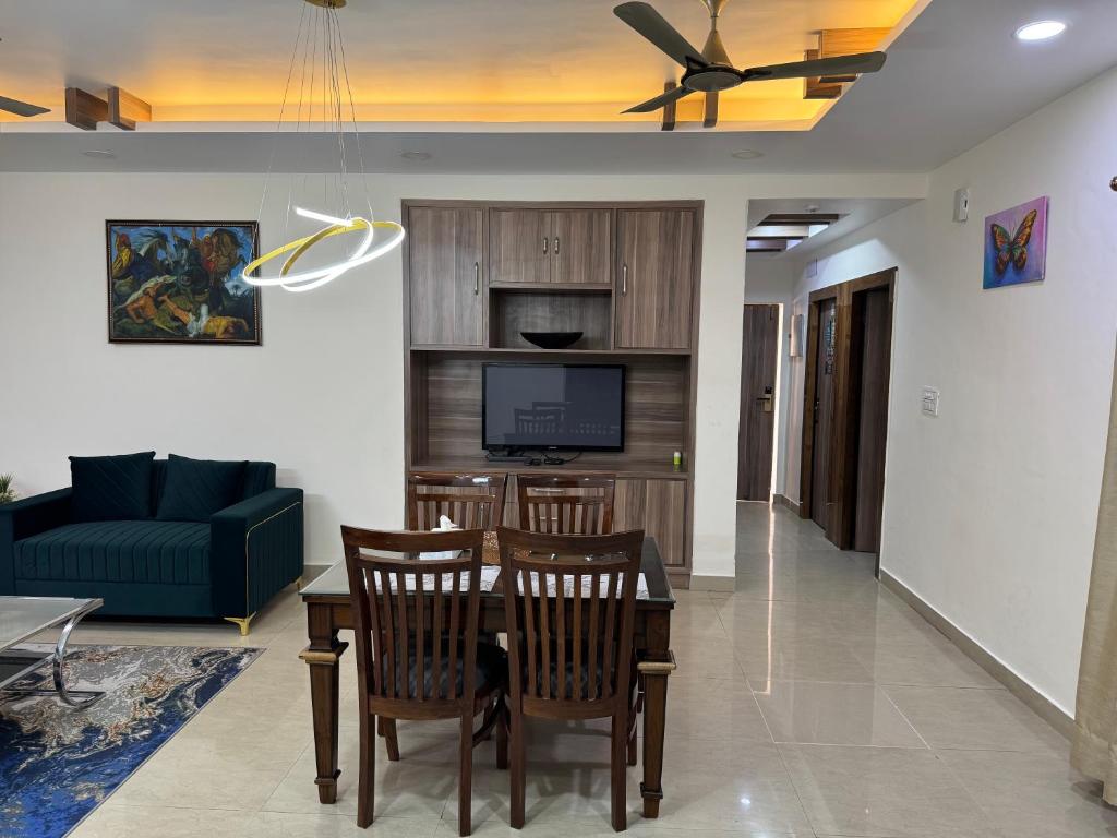 a living room with a table and chairs and a couch at Luxenest Holiday Homes in Jammu