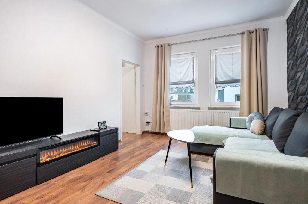 a living room with a couch and a fireplace at Ferienwohnung Krause Dachgeschoss in Wilhelmshaven