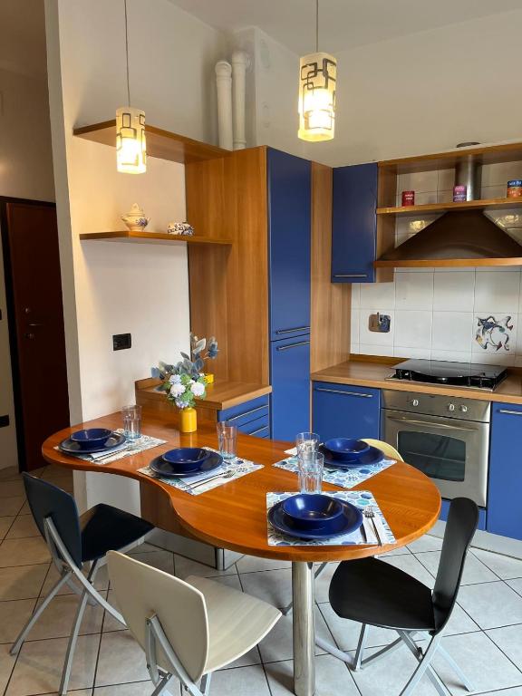 Hotel La Casa di Mati, a kitchen with a wooden table and blue cabinets at La Casa di Mati in Bologna