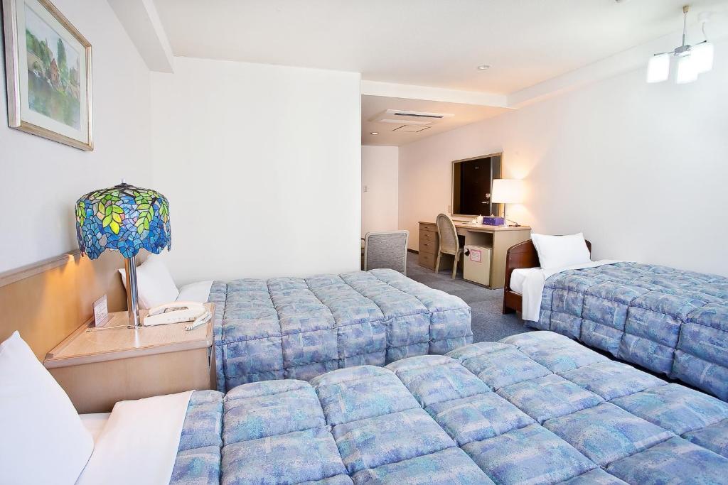 Postel nebo postele na pokoji v ubytování Hotel Luna Park