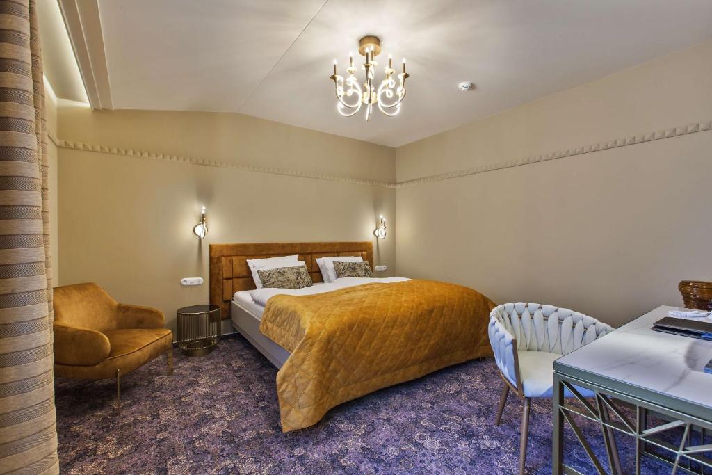 Postel nebo postele na pokoji v ubytování Mestský Hotel Ďumbier