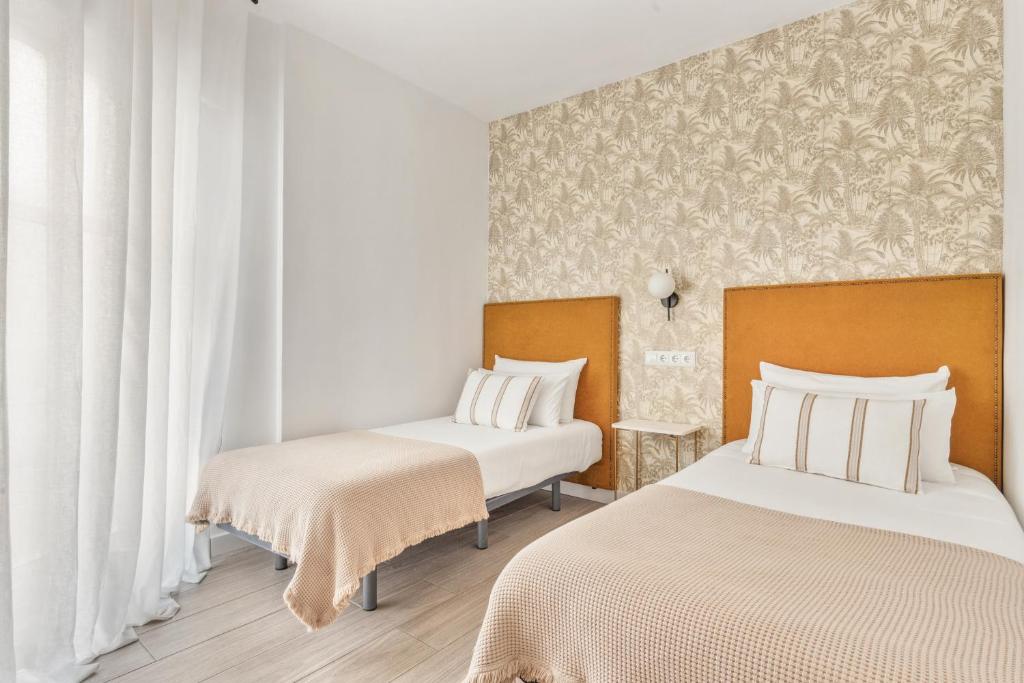 Posteľ alebo postele v izbe v ubytovaní Epidemia & quite bedrooms by ELE Apartments