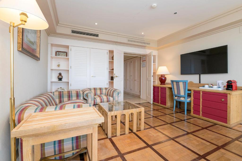 a living room with a couch and a table at Hotel Playa Victoria in Cádiz