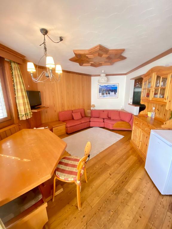 a living room with a couch and a table at SuperG apartment in St. Moritz