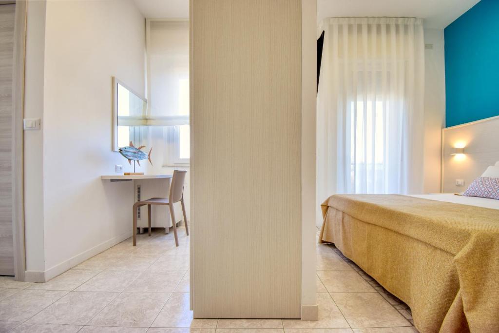 Postel nebo postele na pokoji v ubytování Ambra Hotel Cattolica