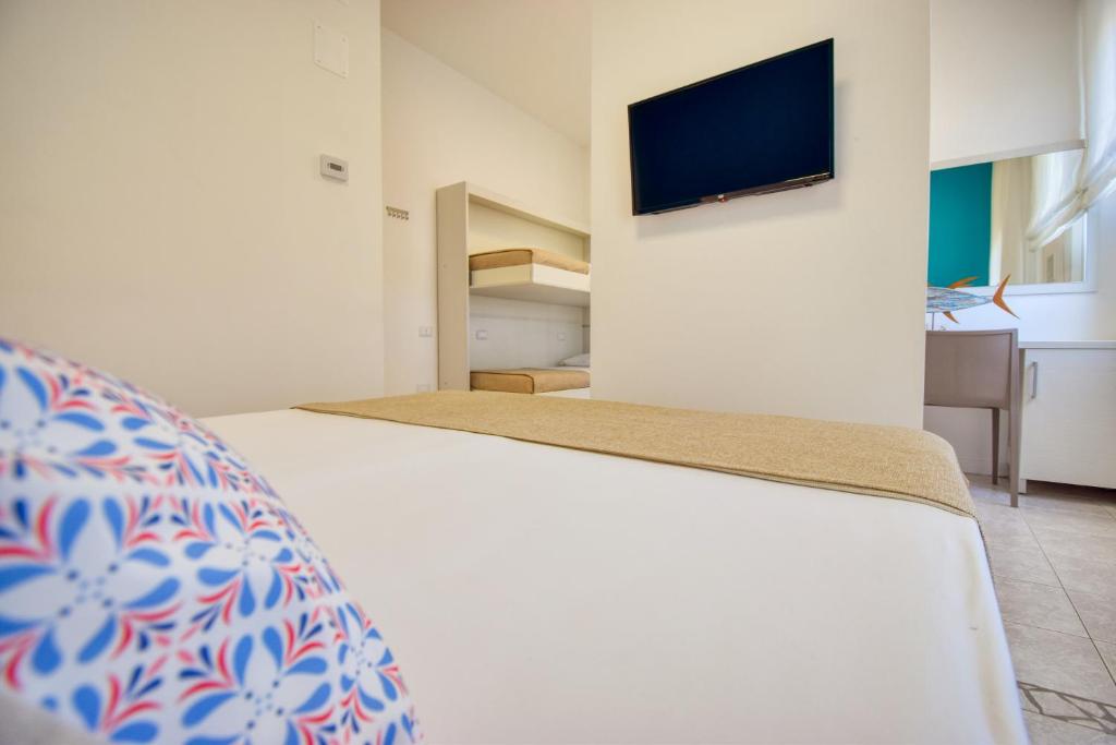 Postel nebo postele na pokoji v ubytování Ambra Hotel Cattolica