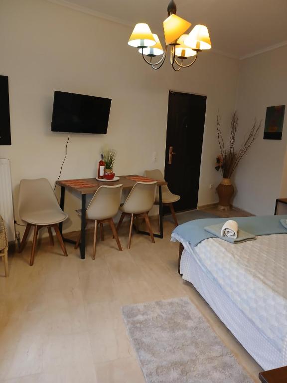 a bedroom with a bed and a table and chairs at Athina in Thessaloniki