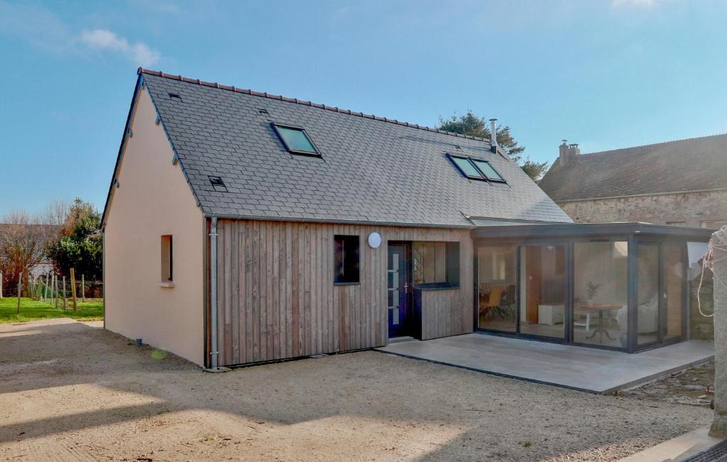 an extension to a house with sliding glass doors at Stunning Home In Flottemanville-Hague in Flottemanville-Hague