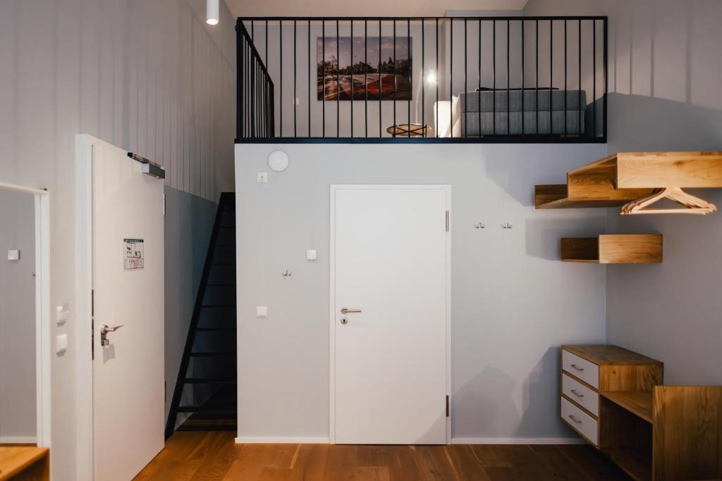 a room with white cabinets and a bed on a shelf at The Layhead B&B in Lübeck