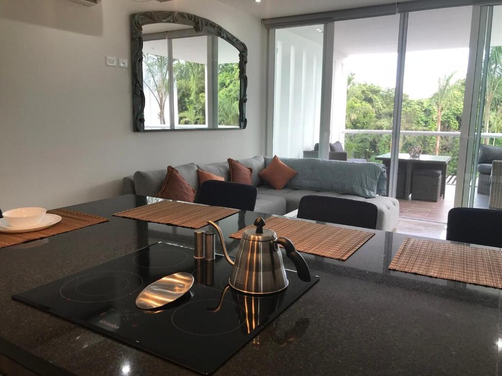 ein Wohnzimmer mit einem Wasserkocher auf dem Tisch in der Unterkunft Stunning 2Bd 2Ba 5 Star Golf Resort in Chacalal