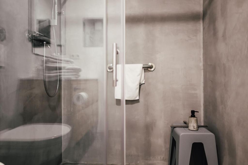 a bathroom with a shower with a toilet and a sink at The Layhead B&B in Lübeck